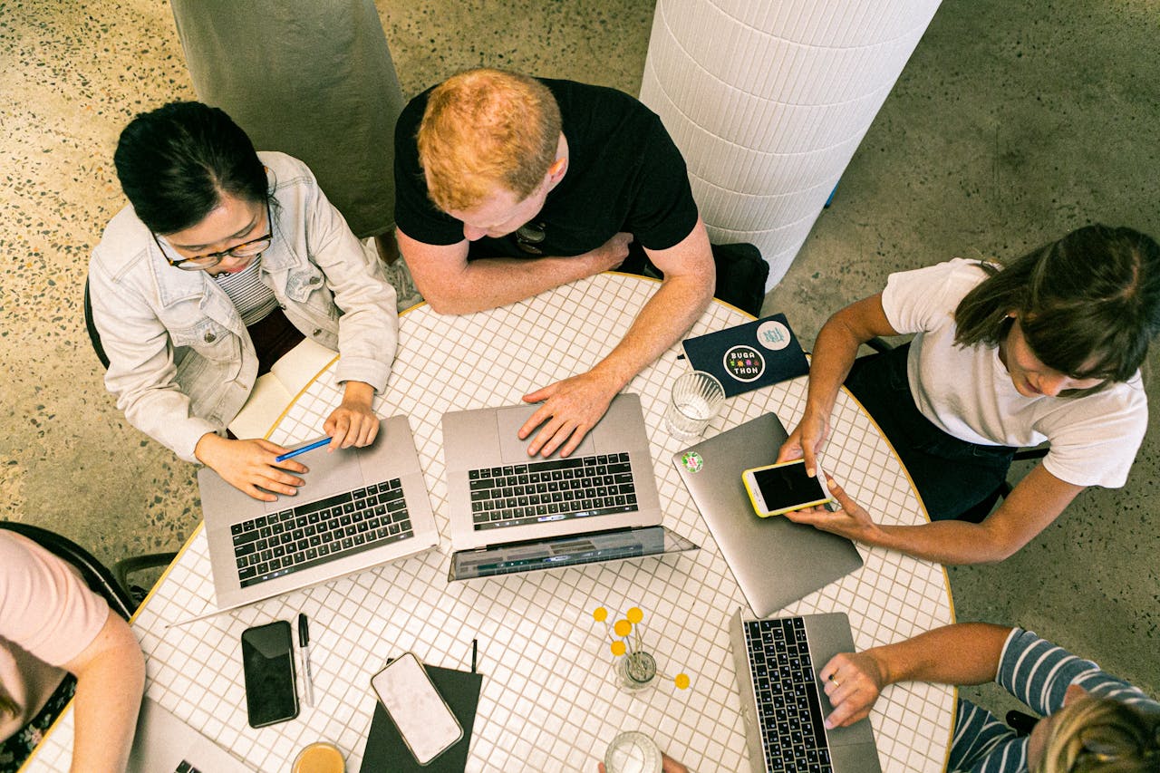 home-services-004 Top view of diverse team collaboratively working in a modern office setting.